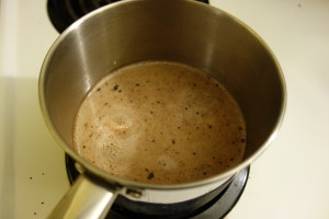 pot of water simmering on stove with brewing cacao and milk
