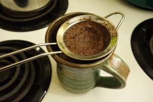 brewed cacao being strained into mug